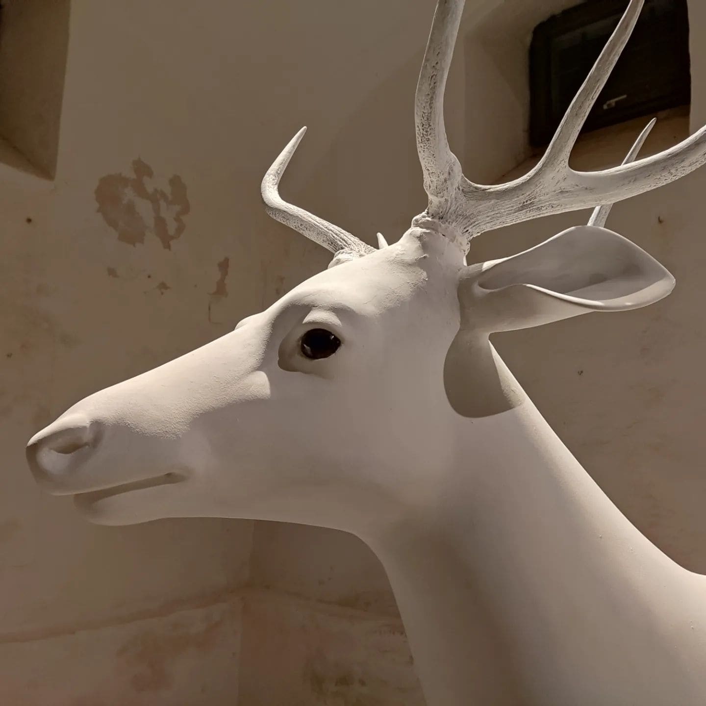Close view of the white stag sculpture and its antlers